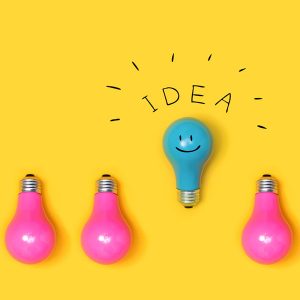 One outstanding idea concept with light bulbs on a yellow background